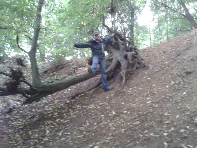 Paul hangs from a tree up a very steep bank