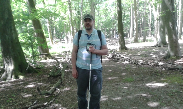Paul stands in the woods.